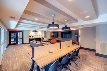 A conference room with a long table and chairs.